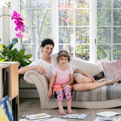 Jaclyn Stein sitting on the sofa with her daughter, Claire. 